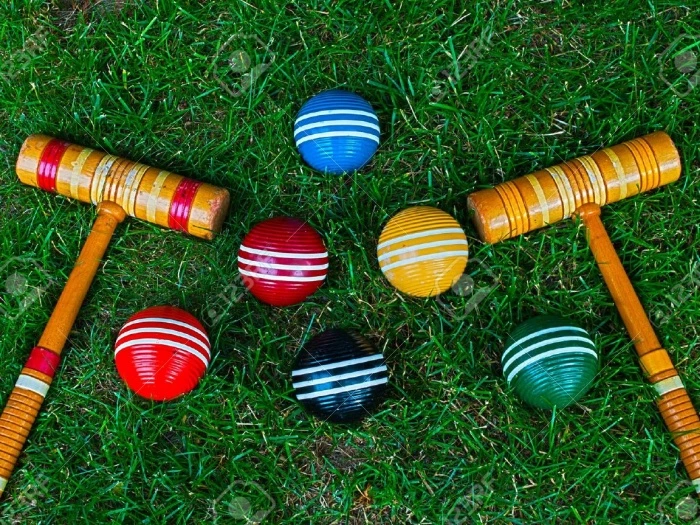 9700528croquetmalletsandballsongrassbackgroundstockphotocroquet