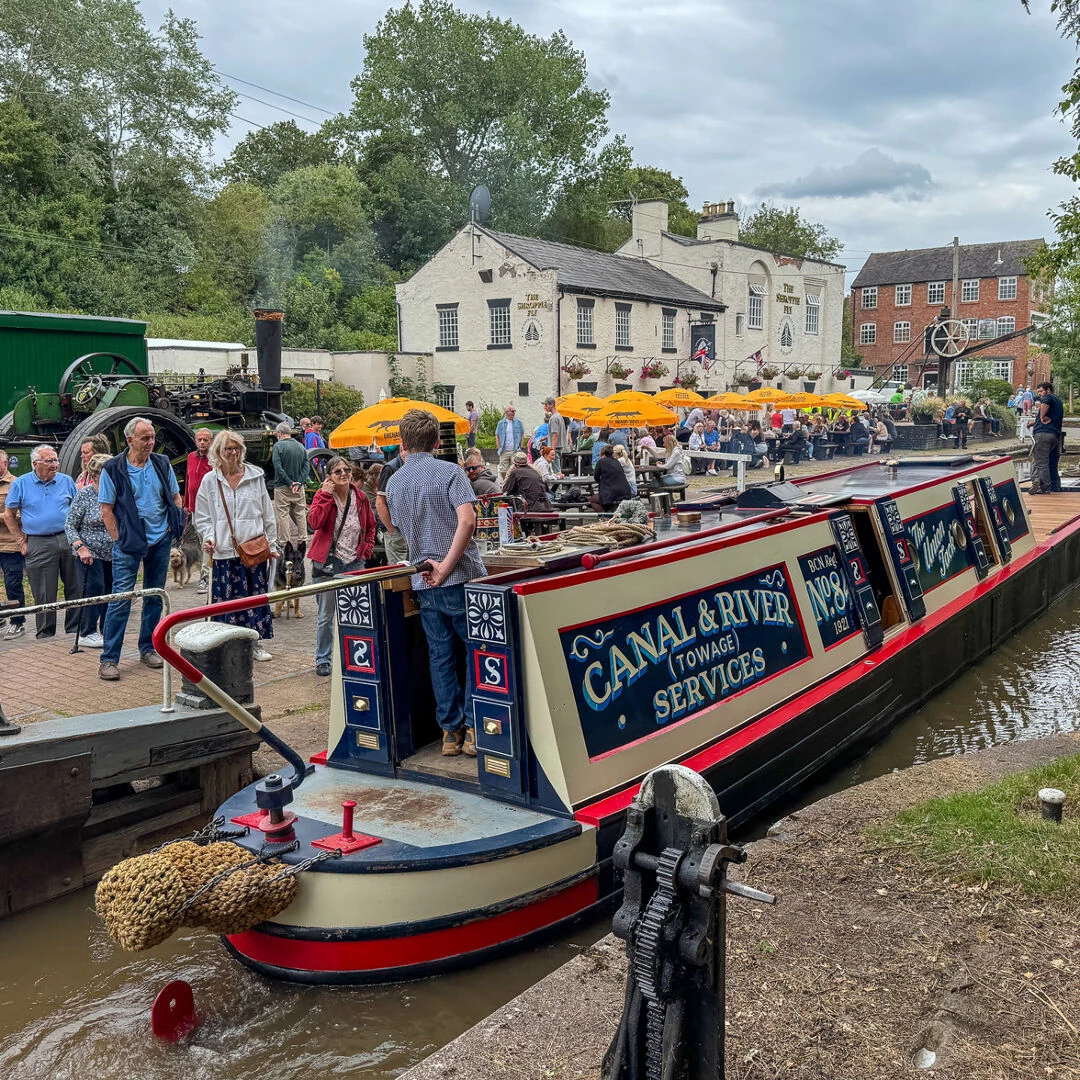 a narrowboat passes through a lock at audlem wharf