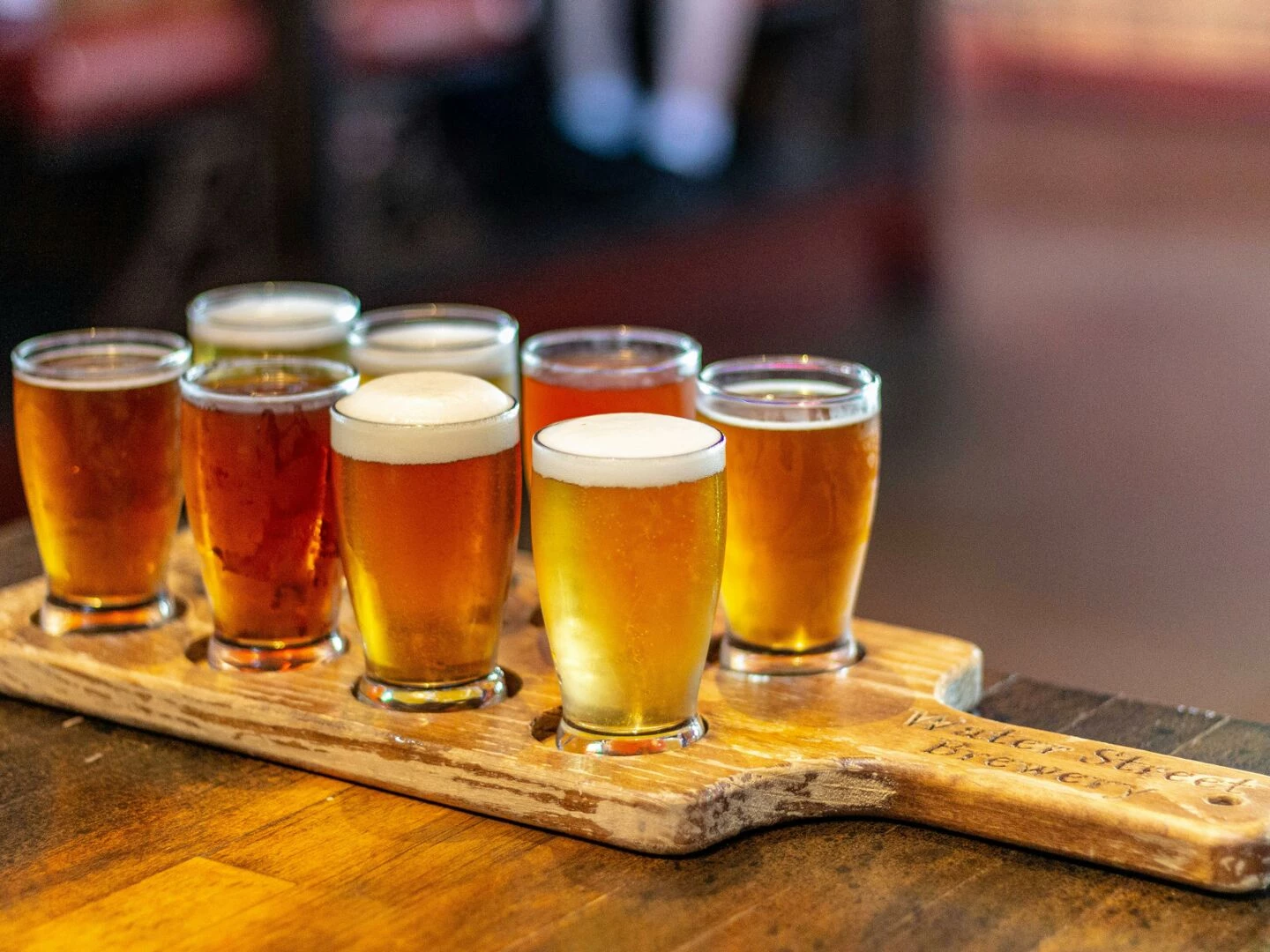 a selection of craft beers on a board at a milwaukee pub