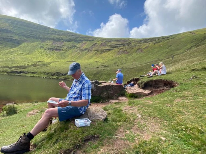 alan and group enjoying lunch on way down from pen y fan