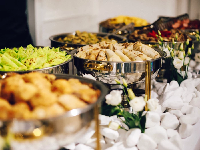 beautifully decorated catering banquet table with different food snacks and appetizers