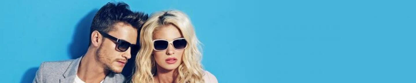 Couple wearing sunglasses on blue background