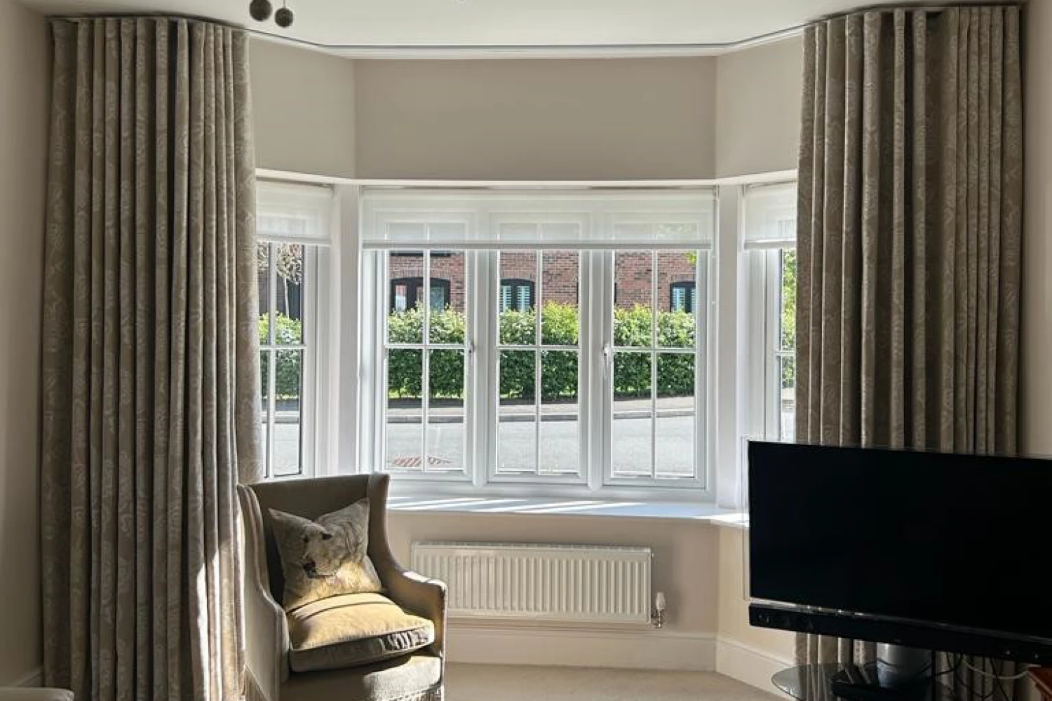 Wave heading curtains in bay window