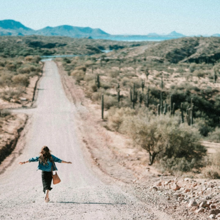 Woman Walking on Dirt Road