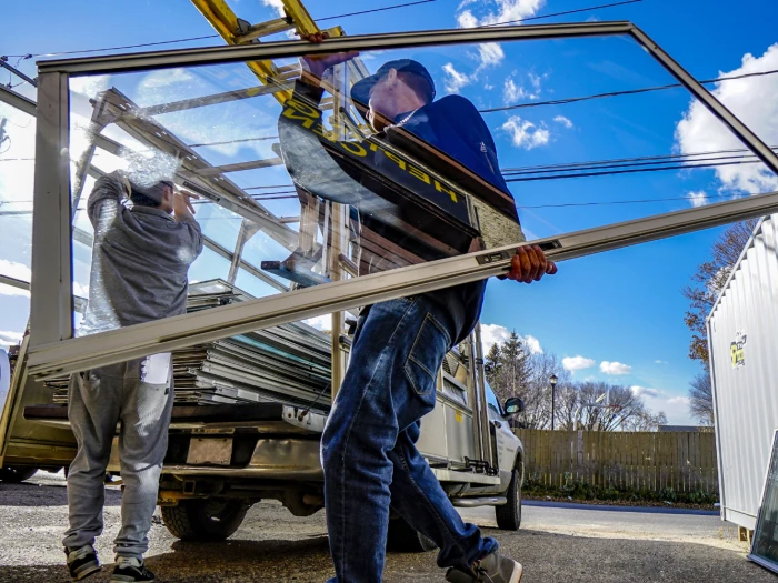 Workers unloading aluminium window