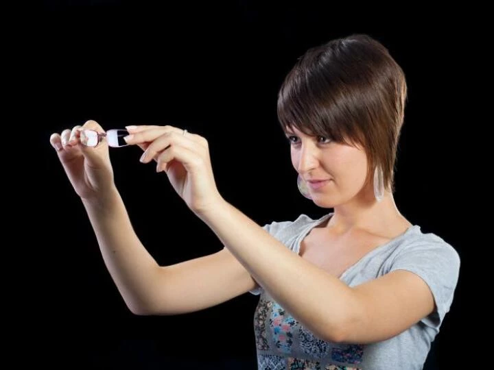 Woman inspects spectacles