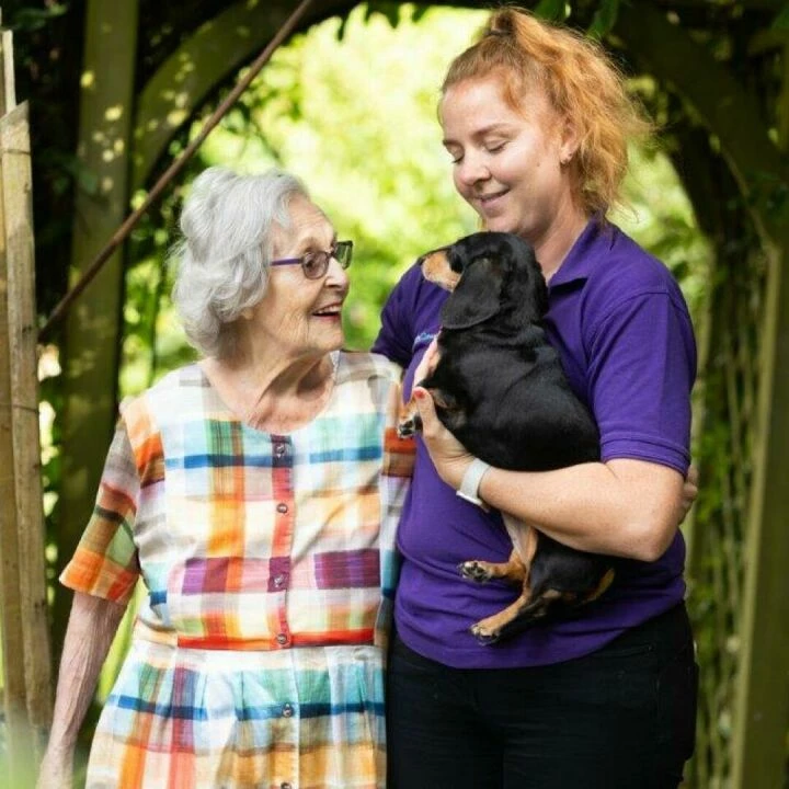 Ann in Her Garden With Her Dog Amei and Carer Jody