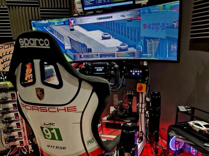 Racing sim rig view from behind with a white cockpit seat