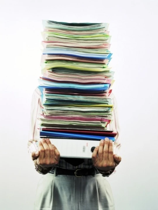 businessmancarryingpileoffilesm34903