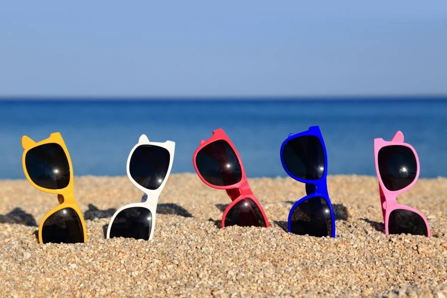 collection of sunglasses on the beach