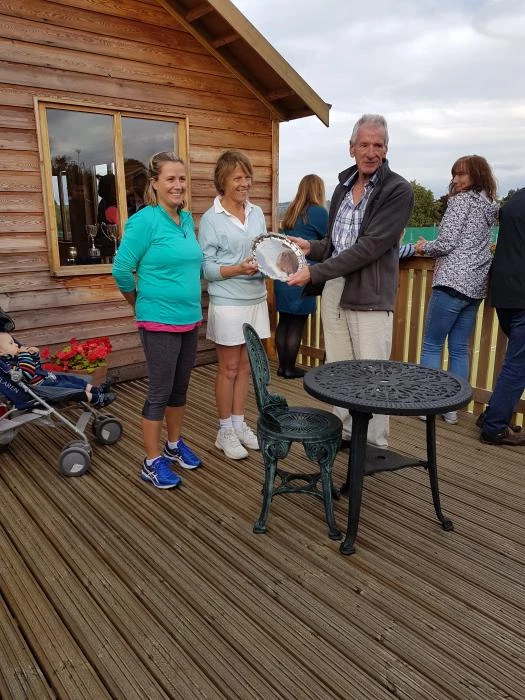 current chairman chris edwards presents the trophy to the ladies doubles winners karen elliott and rowena okell 2018 20180909174045