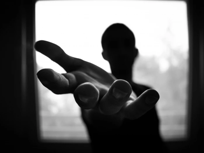 man39s hand in shallow focus and grayscale photography