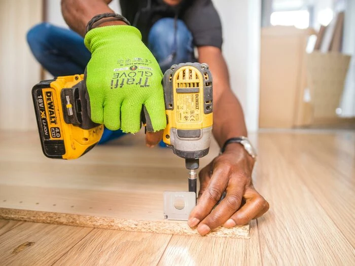 person using dewalt cordless impact driver on brow