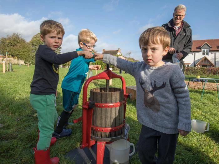 pressing apple pulp with child labour