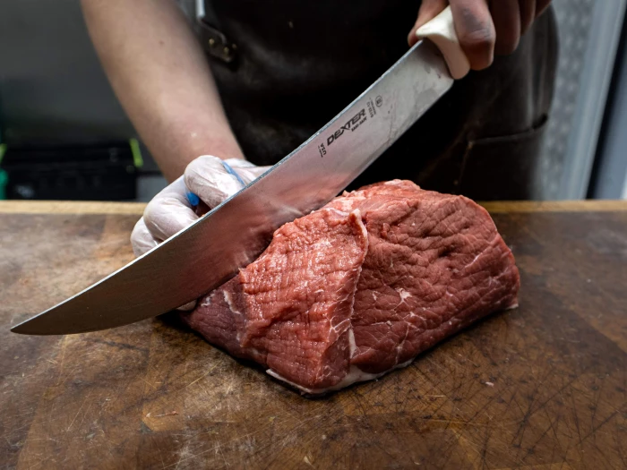 slicing beef on chopping board