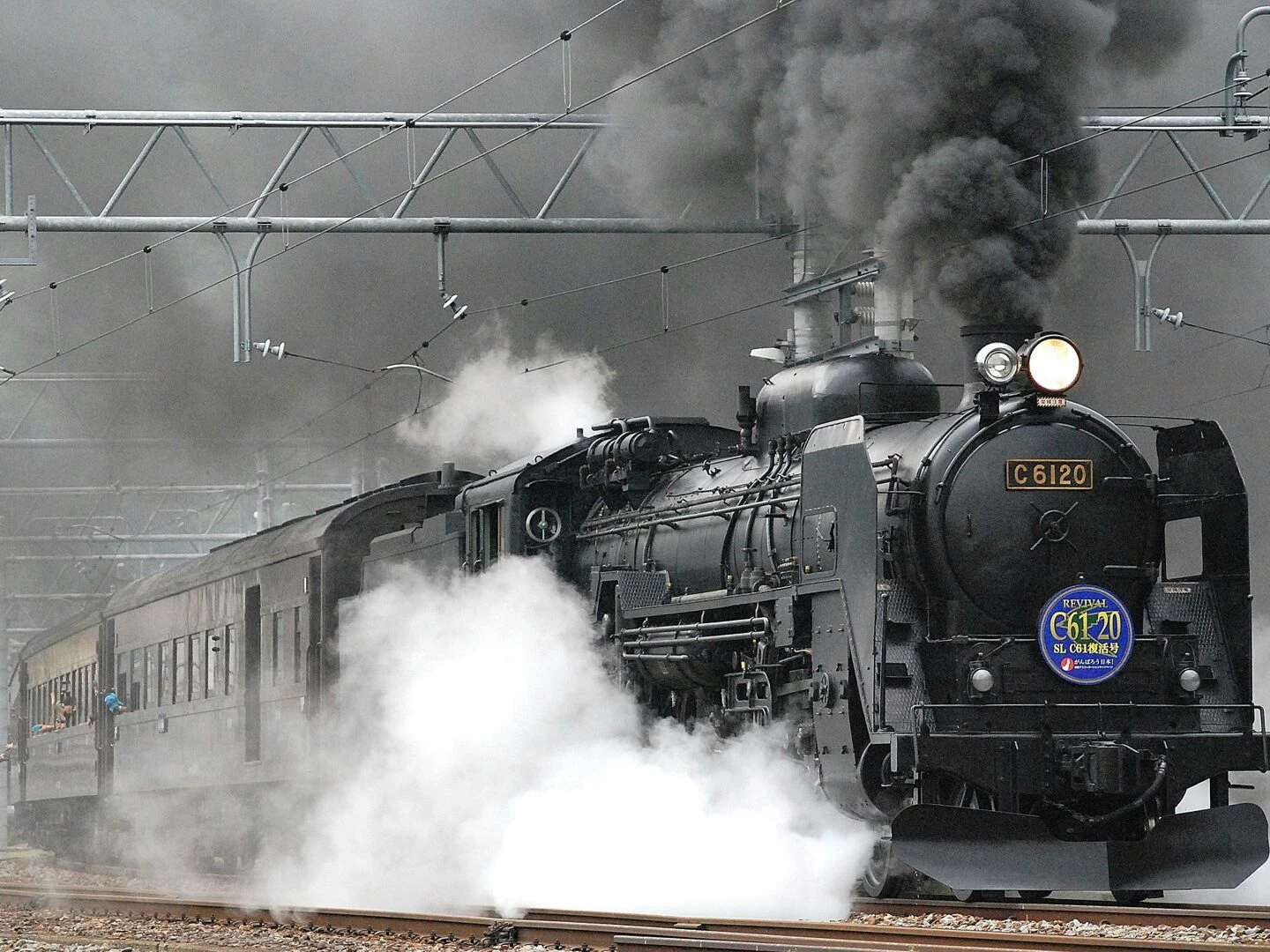 steam locomotive releasing smoke and steam on a rail track showcasing vintage train transportation