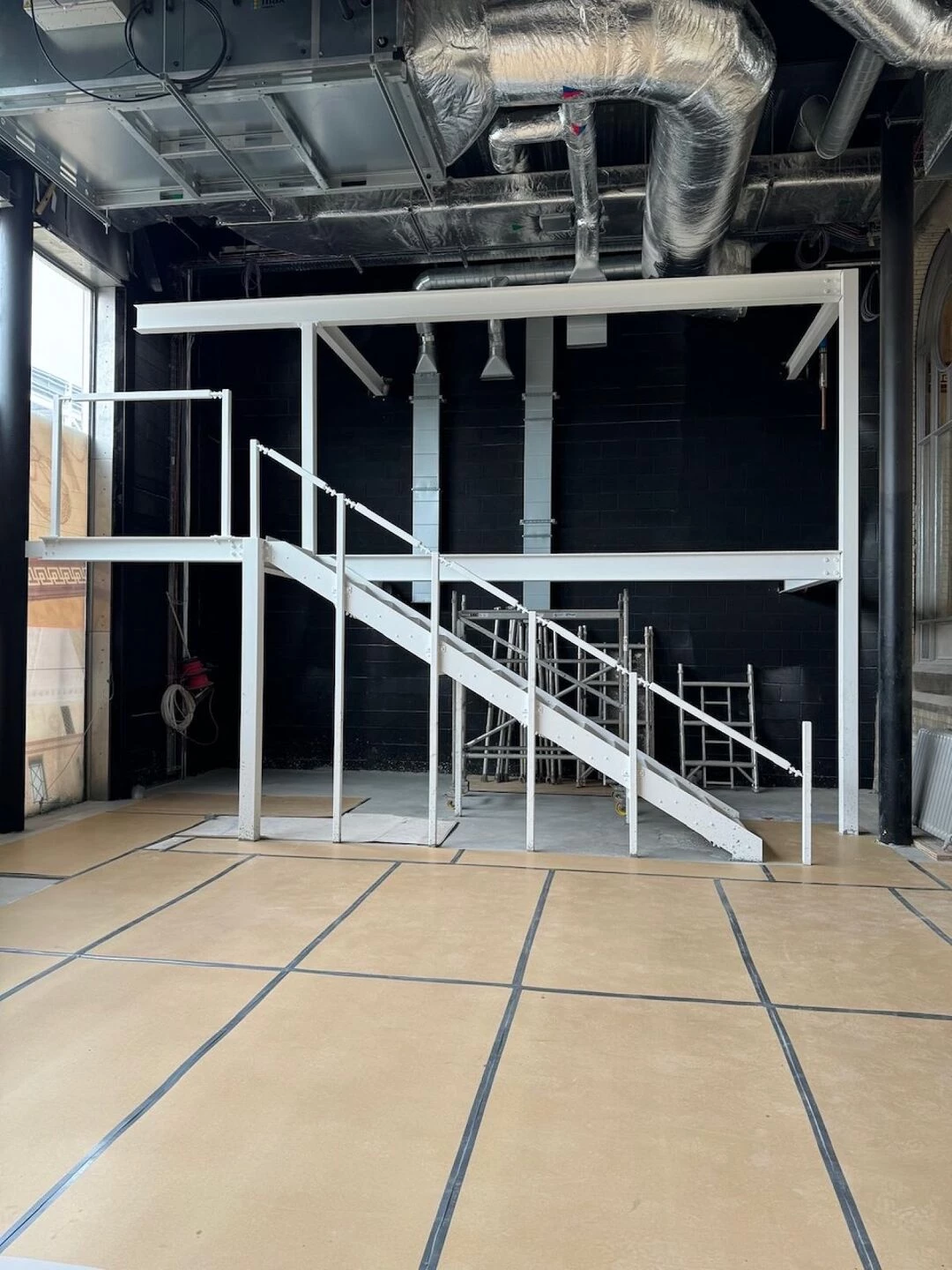 warehouse construction featuring metal staircase and steel framework