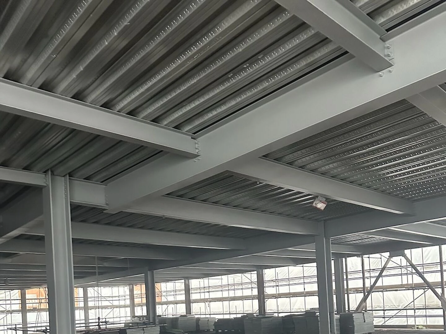 warehouse interior with large windows and concrete floor