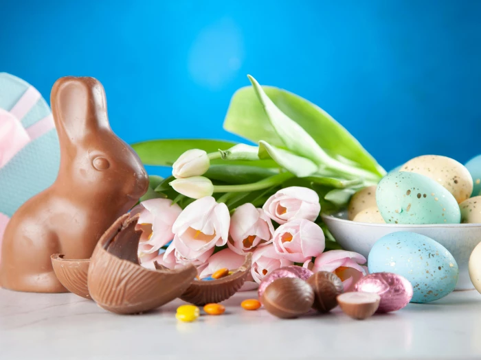 white flowers between brown rabbit figure and eggs