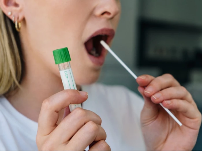 woman taking a lateral flow test
