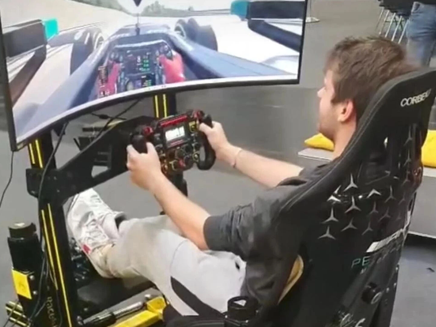 young man driving in a racing simulator